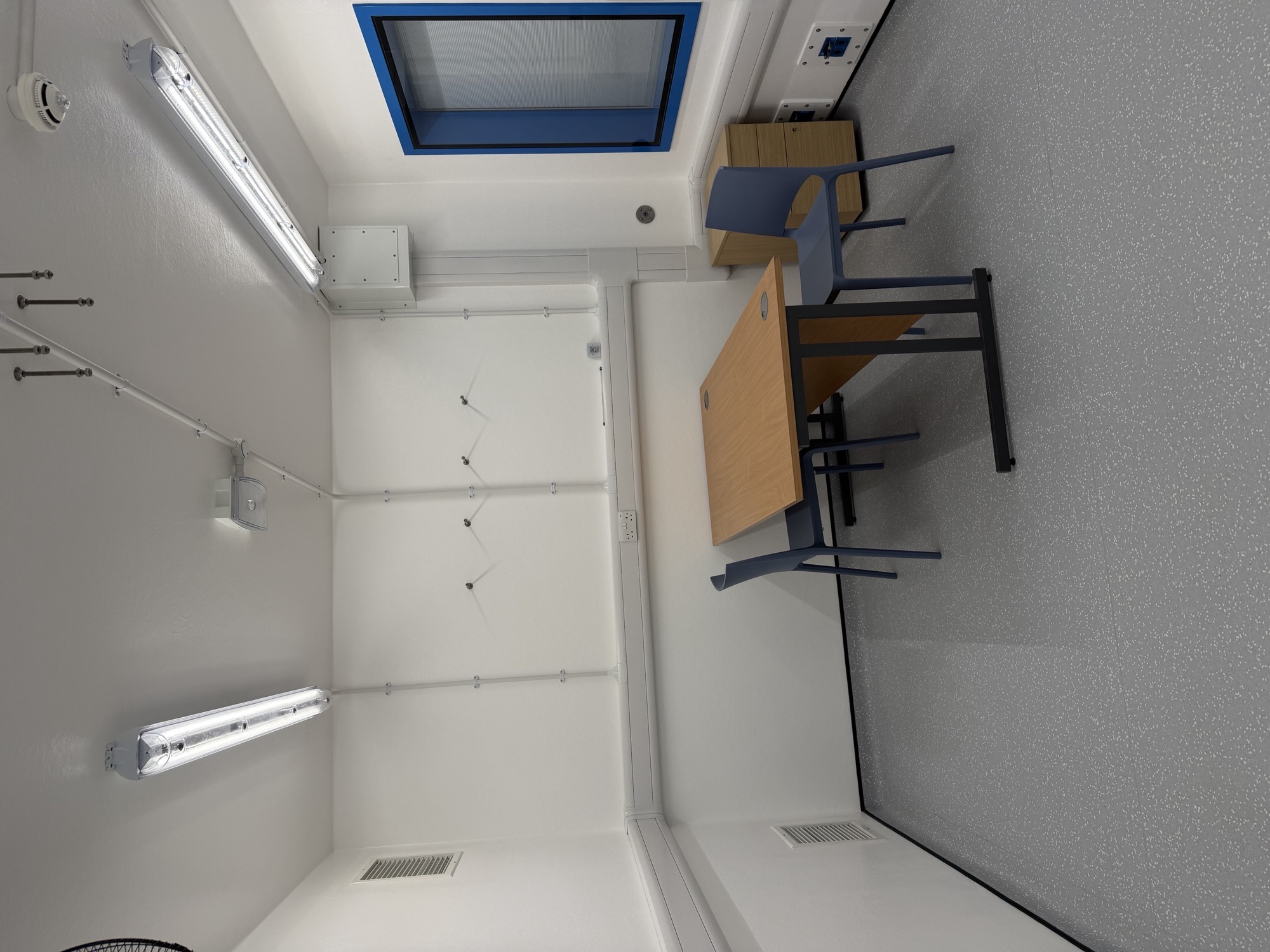 Interior of the aerobiology chamber arranged as an office, with wall-mounted airspeed sensors and controlled supply and extract